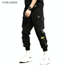 Load image into Gallery viewer, Streetwear hip hop preto harem calças dos homens de cintura elástica calças do punk com fitas casual magro jogger calças de hip hop