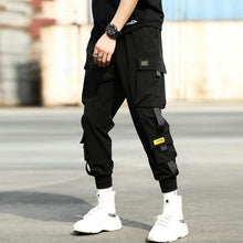 Load image into Gallery viewer, Streetwear hip hop preto harem calças dos homens de cintura elástica calças do punk com fitas casual magro jogger calças de hip hop